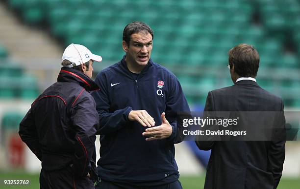 Martin Johnson the England head coach, talks to Rob Andrew, the RFU Elite Director of rugby and attack coach Brian Smith during the England training...