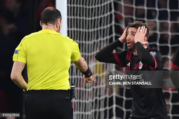 Milan's Italian striker Fabio Borini reacts to the granting of a penalty leading to Arsenal's first goal during the UEFA Europa League round of 16...