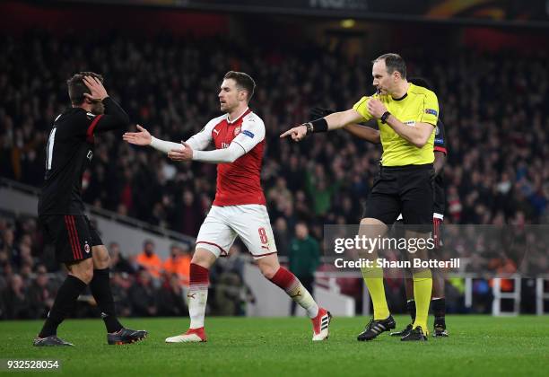 Referee Jonas Eriksson awards a penalty to Arsenal after a foul on Danny Welbeck during the UEFA Europa League Round of 16 Second Leg match between...