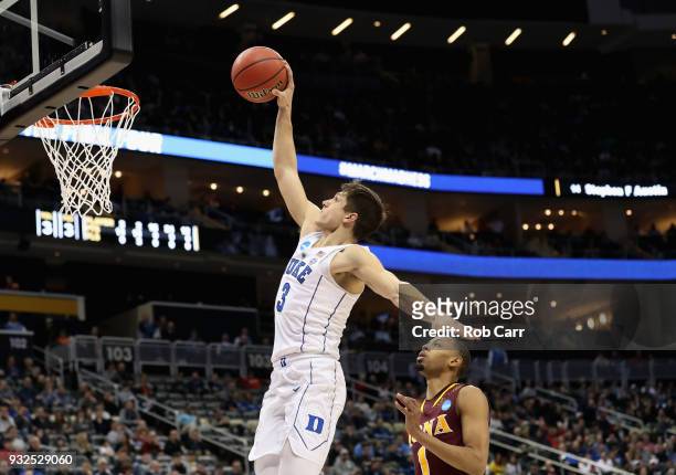 Grayson Allen of the Duke Blue Devils takes a shot ahead of Zach Lewis of the Iona Gaels during the second half of the game in the first round of the...