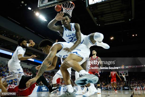 Desi Rodriguez and Sandro Mamukelashvili of the Seton Hall Pirates collide in the first half against the North Carolina State Wolfpack during the...