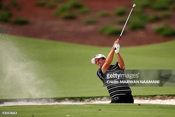 Australia's Adam Scott plays a bunker shot during the second round of the 7.5-million-dollar Dubai World Championship at the 7,675-yard Earth Course...