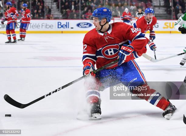 Byron Froese of the Montreal Canadiens controls the puck against the Dallas Stars in the NHL game at the Bell Centre on March 13, 2018 in Montreal,...