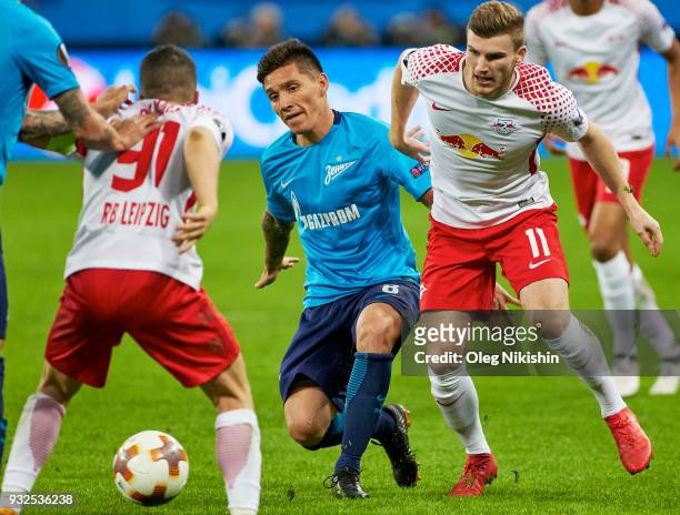 Matias Kranevitter of FC Zenit vies for the ball with Timo Werner and Diego Demme of RB Leipzig during UEFA Europa League Round of 16 match between...