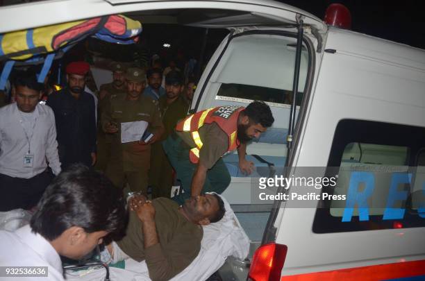 Pakistani rescue workers push a stretcher carrying an injured man to the hospital following the blast of a motorcycle bomb attack. Nine people were...
