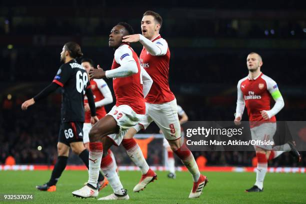 Danny Welbeck of Arsenal celebrates scoring their 1st goal with Aaron Ramsey during the UEFA Europa League Round of 16 2nd leg match between Arsenal...