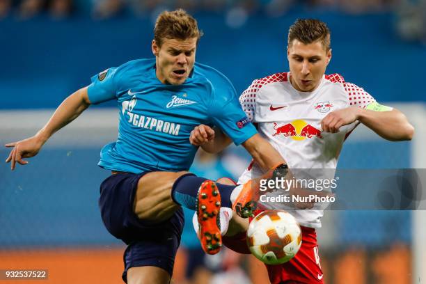 Aleksandr Kokorin of FC Zenit Saint Petersburg and Willi Orban of RB Leipzig vie for the ball during the UEFA Europa League Round of 16 second leg...
