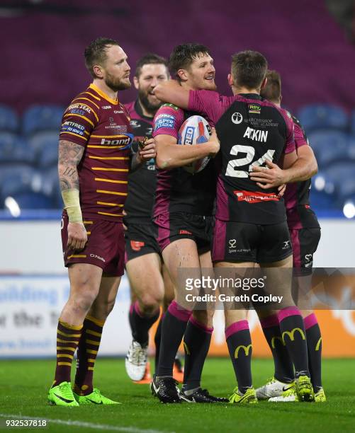 Ryan Shaw of Hull KR celebrates with teammates after scoring a second half try during the Betfred Super League match between Huddersfield Giants and...