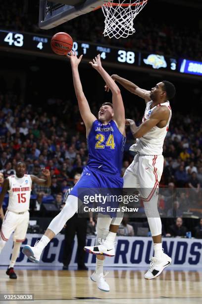 Mike Daum of the South Dakota State Jackrabbits drives to the basket against Keita Bates-Diop of the Ohio State Buckeyes in the first half during the...