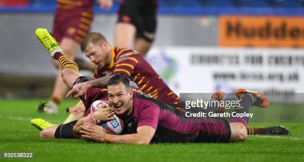 Danny McGuire of Hull KR celebrates with teammates after scoring a second half try during the Betfred Super League match between Huddersfield Giants...