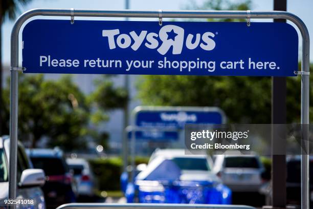 Signage is displayed on a shopping cart return corral in the parking lot of a Toys R Us Inc. Retail store in Miami, Florida, U.S., on Thursday, March...