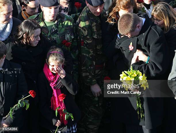 Friends and family including the Queen's senior footman, Fraser Marlton-Thomas and brother of Corporal Loren Marlton-Thomas react as the hearse...