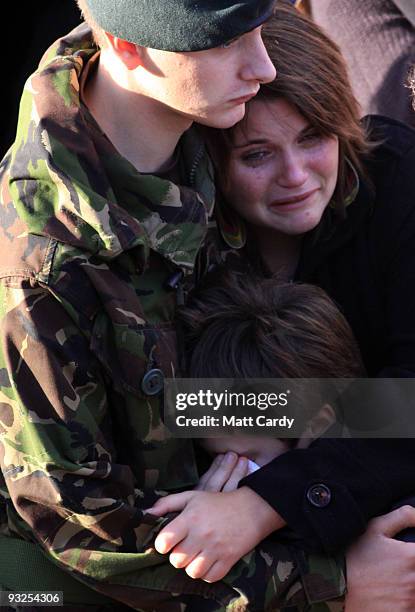 Friends and family react as the hearses carrying the coffins of two dead soldiers pass mourners lining the High Street on November 20, 2009 in...