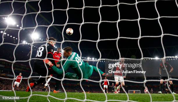 Danny Welbeck of Arsenal heads home the third goal past Gianluigi Donnarumma of AC Milan during the UEFA Europa League Round of 16 Second Leg match...