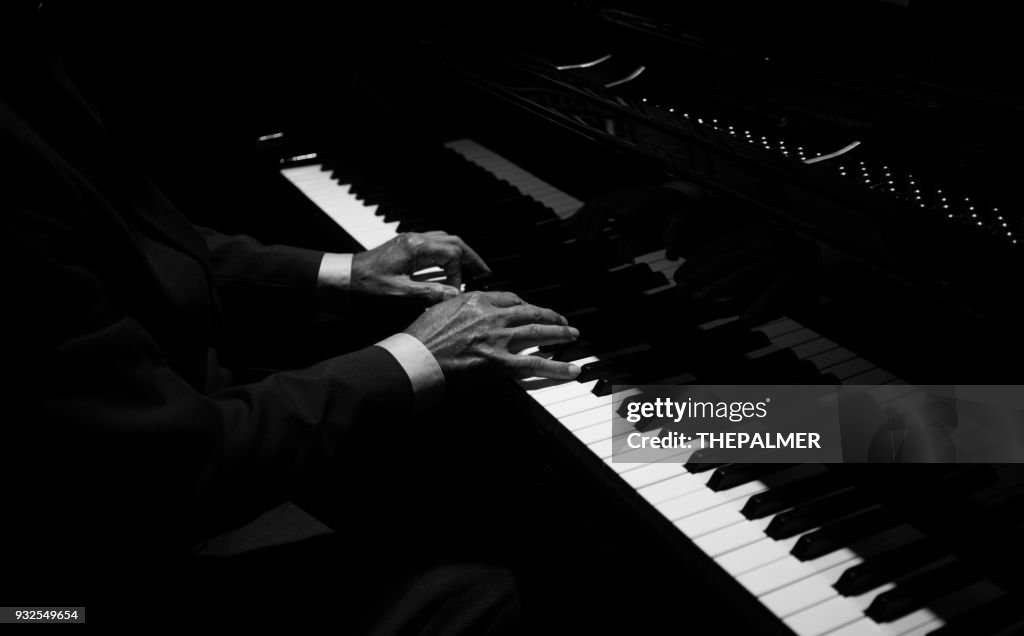 Hands playing the piano