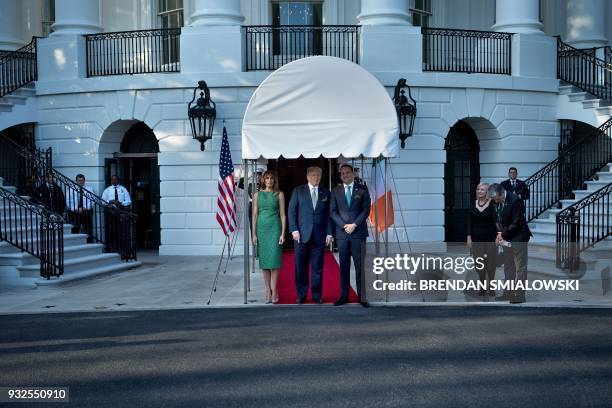 President Donald Trump and US first lady Melania Trump stand with Ireland's Prime Minister Leo Varadkar outside the White House March 15, 2018 in...