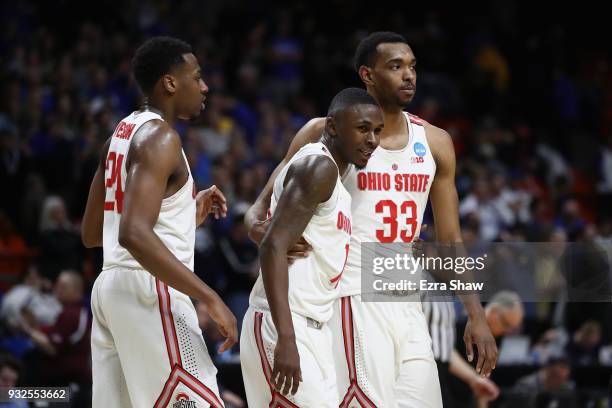 Andre Wesson, Kam Williams and Keita Bates-Diop of the Ohio State Buckeyes celebrate defeating the South Dakota State Jackrabbits 81-73 in the first...