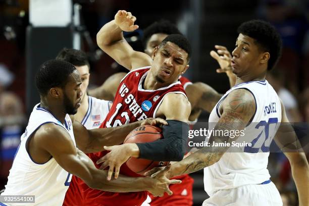 Khadeen Carrington and Desi Rodriguez of the Seton Hall Pirates pressure Allerik Freeman of the North Carolina State Wolfpack in the second half...