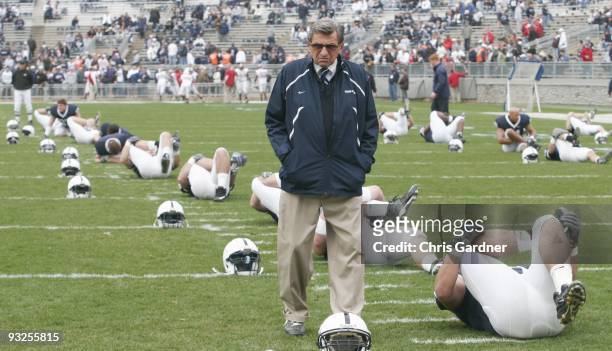 Head coach Joe Paterno of the Penn State Nittany Lions walks through his team as they stretch before their game against the Indiana Hoosiers at...