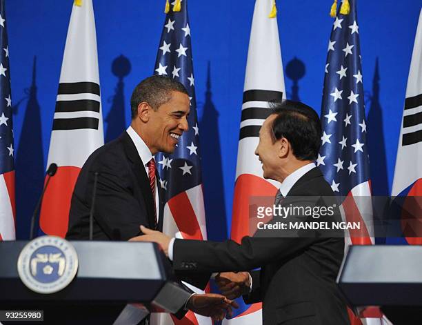 President Barack Obama shakes hands with South Korean President Lee Myung-bak following a joint press conference at the presidential Blue House in...