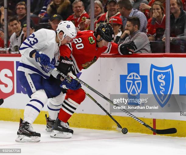 Brandon Saad of the Chicago Blackhawks and Travis Dermott of the Toronto Maple Leafs at the United Center on January 24, 2018 in Chicago, Illinois.
