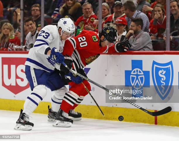 Brandon Saad of the Chicago Blackhawks and Travis Dermott of the Toronto Maple Leafs at the United Center on January 24, 2018 in Chicago, Illinois.