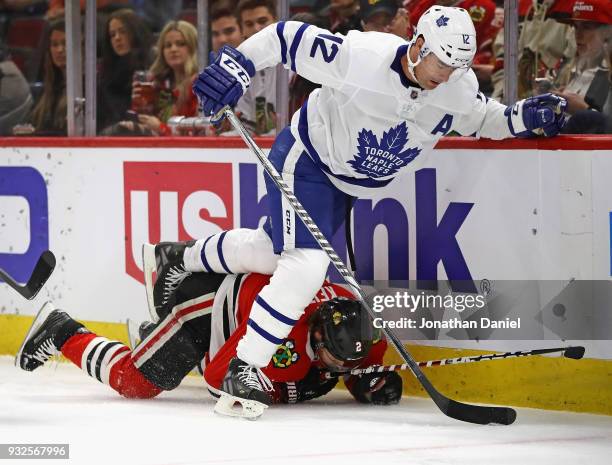 Patrick Marleau of the Toronto Maple Leafs hops over Duncan Keith of the Chicago Blackhawks as he chases the puck at the United Center on January 24,...