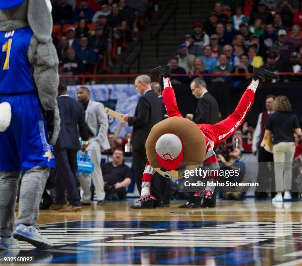 Brutus the Buckeye gets busy in a dance-off with South Dakota State's Jack the Jack Rabbit during the first round of the NCAA Tournament West...