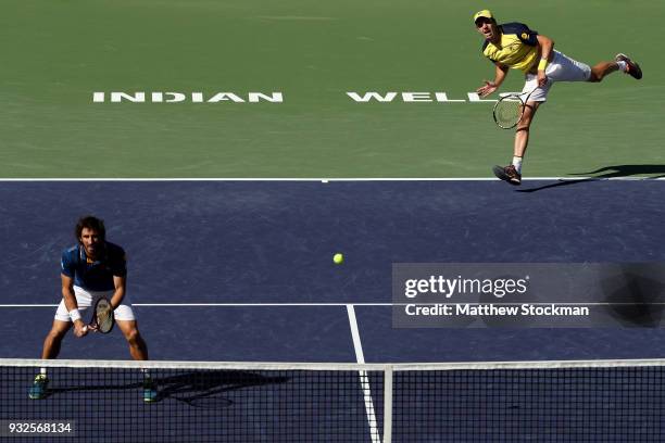 Horacio Zeballos of Argentina serves to Gilles Muller of Luxemburg and Sam Querrey while playing with Pablo Cuevas of Uraguay during the BNP Paribas...