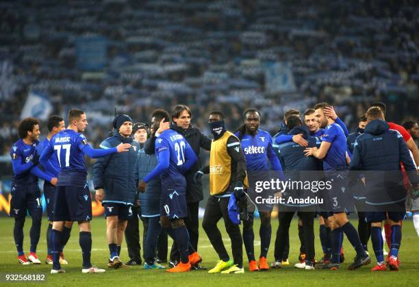 Head coach of Lazio Simone Inzagh and his players celebrate after winning the Europa League round 16 second second leg football match between FC...