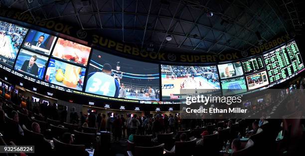 Guests attend a viewing party for the NCAA Men's College Basketball Tournament inside the 25,000-square-foot Race & Sports SuperBook at the Westgate...