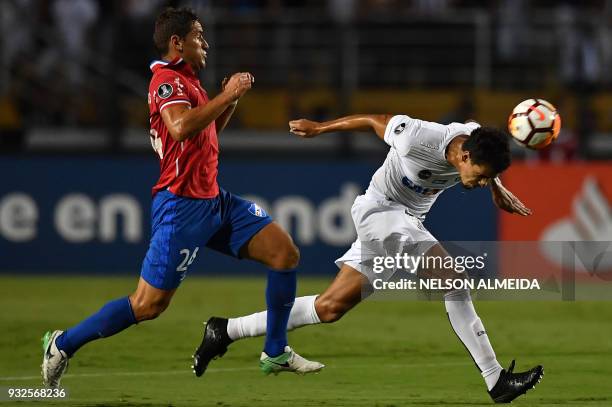 Leo Cittadini of Brazil's Santos, vies for the ball with Gonzalo Bergessio of Uruguay's Nacional, during their 2018 Copa Libertadores football match...