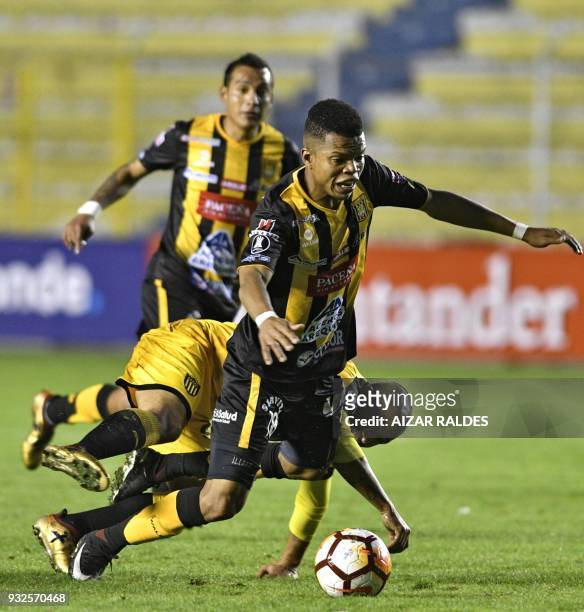 Edis Ibarguen of Bolivia's The Strongest vies for the ball with Walter Gargano of Uruguayan Penarol during their Copa Libertadores football match, at...