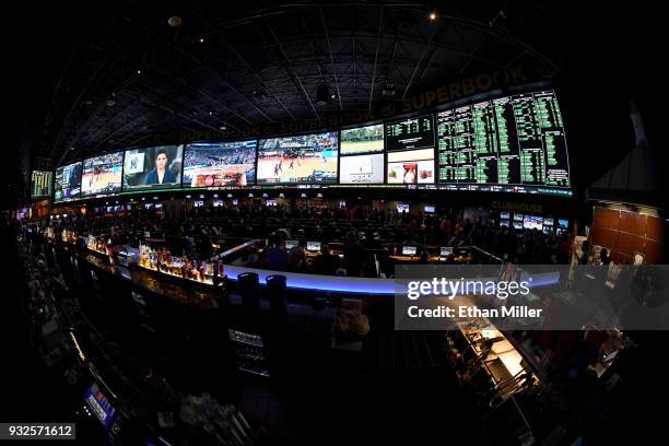 Guests attend a viewing party for the NCAA Men's College Basketball Tournament inside the 25,000-square-foot Race & Sports SuperBook at the Westgate...