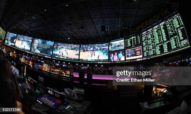 Guests attend a viewing party for the NCAA Men's College Basketball Tournament inside the 25,000-square-foot Race & Sports SuperBook at the Westgate...