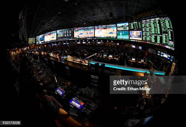 Guests attend a viewing party for the NCAA Men's College Basketball Tournament inside the 25,000-square-foot Race & Sports SuperBook at the Westgate...