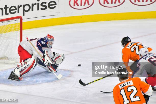 Philadelphia Flyers defenseman Brandon Manning firs his shot wide against Columbus Blue Jackets goaltender Sergei Bobrovsky during the NHL game...