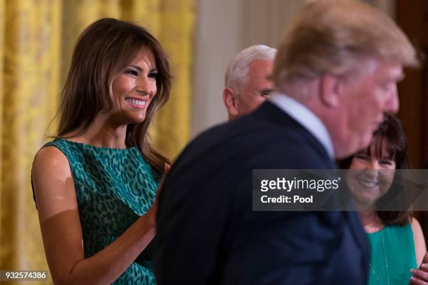 First lady Melania Trump claps as United States President Donald J. Trump speaks during the Shamrock Bowl Presentation at the White House on March...