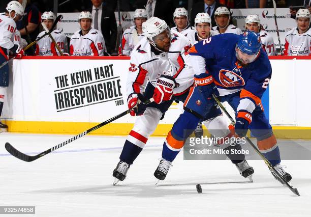 Nick Leddy of the New York Islanders and Devante Smith-Pelly of the Washington Capitals battle for the puck during the first period at Barclays...