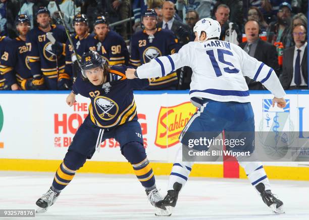 Nathan Beaulieu of the Buffalo Sabres fights with Matt Martin of the Toronto Maple Leafs during an NHL game on March 15, 2018 at KeyBank Center in...