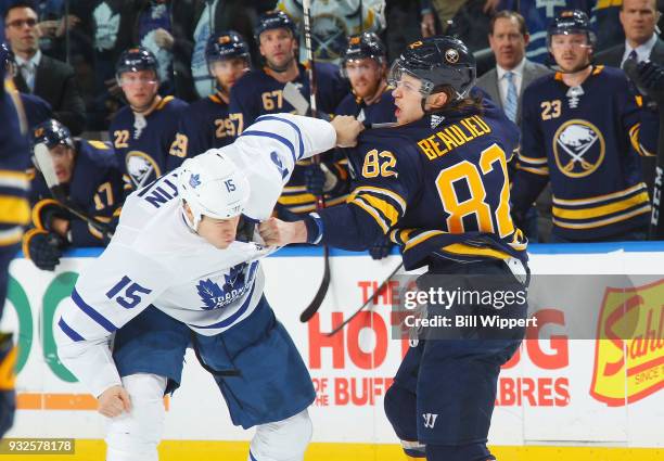 Nathan Beaulieu of the Buffalo Sabres fights with Matt Martin of the Toronto Maple Leafs during an NHL game on March 15, 2018 at KeyBank Center in...