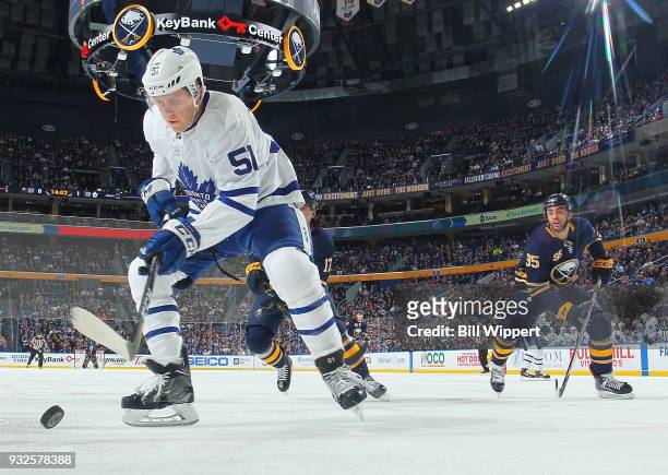 Jake Gardiner of the Toronto Maple Leafs controls the puck against Justin Bailey of the Buffalo Sabres during an NHL game on March 15, 2018 at...
