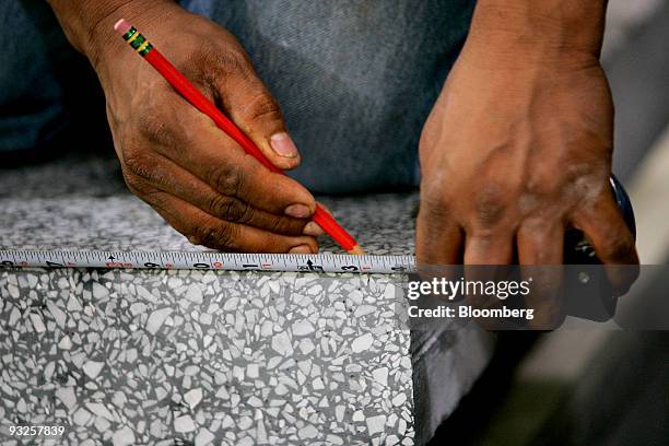 Worker marks a precast terrazzo faux-marble stair tread at the Precast Terrazzo Enterprises Inc. Manufacturing facility in Raleigh, North Carolina,...