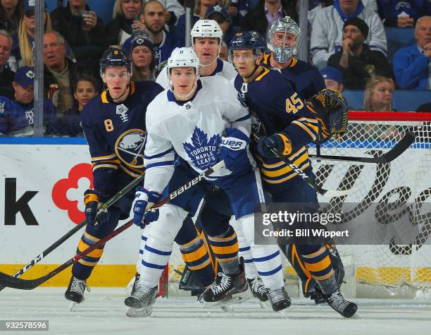 Zach Hyman and Patrick Marleau of the Toronto Maple Leafs are defended by Casey Nelson, Brendan Guhle and Robin Lehner of the Buffalo Sabres during...