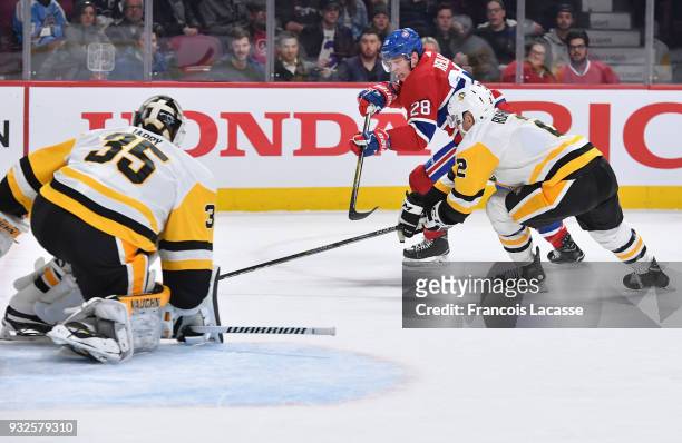 Mike Reilly of the Montreal Canadiens skates against Chad Ruhwedel of the Pittsburgh Penguins in the NHL game at the Bell Centre on March 15, 2018 in...