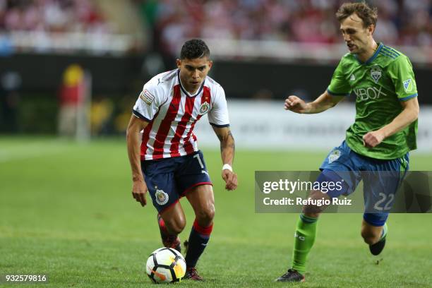 Orbelin Pineda of Chivas fights for the ball with Magnus Wolff Eikrem of Seattle Sounders during the quarterfinals second leg match between Chivas...