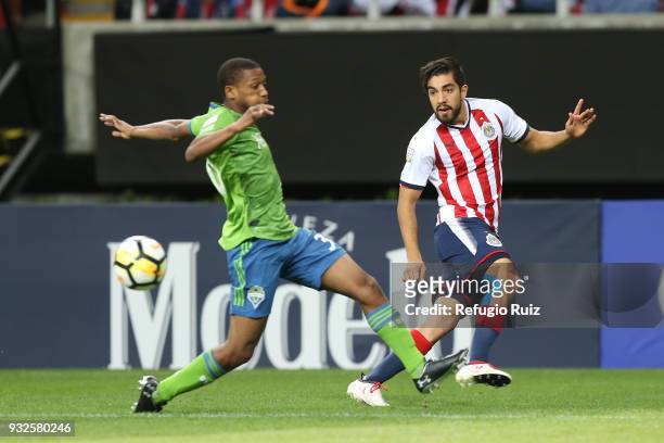 Rodolfo Pizarro of Chivas fights for the ball with Jordan McCrary of Seattle Sounders during the quarterfinals second leg match between Chivas and...