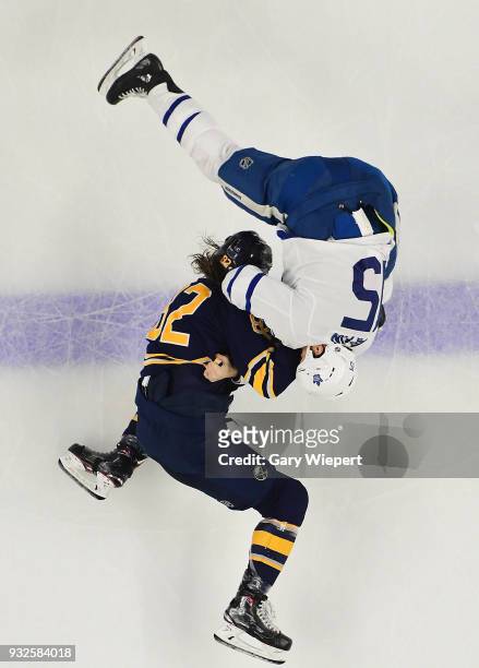 Nathan Beaulieu of the Buffalo Sabres fights with Matt Martin of the Toronto Maple Leafs during an NHL game on March 15, 2018 at KeyBank Center in...