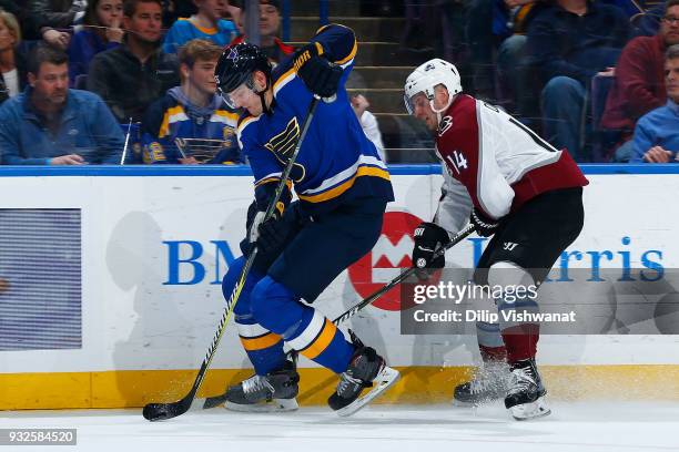 Colton Parayko of the St. Louis Blues controls the puck against Blake Comeau of the Colorado Avalanche at Scottrade Center on March 15, 2018 in St....