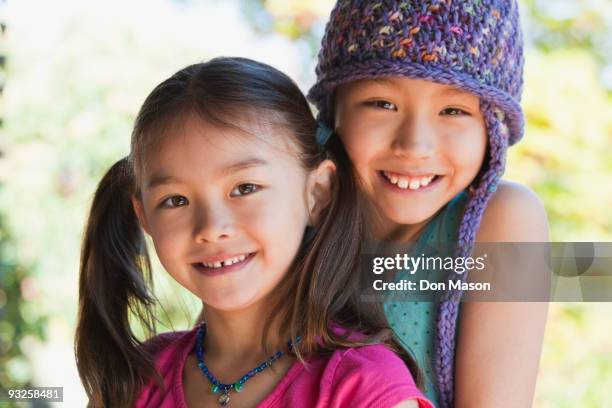 girls hugging and smiling - 二つに結んだ髪 ストックフォトと画像